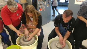Max Major (left) from K 106.3 and Martin Vrolyk (right), Sales and Operations Manager at Blackburn Sarnia, each give pottery a try. February 23, 2018. (Photo by Colin Gowdy, Blackburn News)