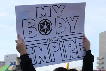 A woman holds up a sign at the Women's March in Windsor January 20, 2018. (Photo by Adelle Loiselle)