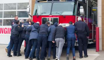 Tecumseh firefighters and town officials symbolically push a new aerial platform truck into fire headquarters, November 20, 2025. Photo courtesy Tecumseh Fire and Rescue.