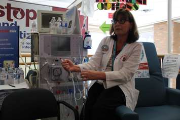 RN Madeline Power demonstrates how a dialysis machine is used at Windsor Regional Hospital, March 12, 2015. (Photo by Mike Vlasveld)