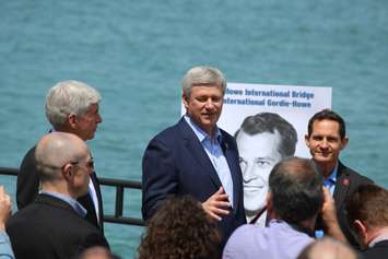 Prime Minister Stephen Harper, Michigan Gov. Rick Snyder and members of the Howe family unveil the name of Windsor-Detroit's new bridge, May 14, 2015. (Photo by Mike Vlasveld)