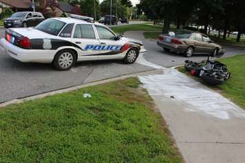 A motorcycle driver has been taken to hospital after colliding with a car on Riverside Dr. W at Askin Ave., June 19, 2015. (Photo by Jason Viau)