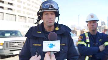 Fire Investigator Rick Destroff updates media outside Kenwick Place. Nov. 25, 2015. Photo by Jake Jeffrey (blackburnnews.com)