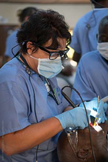  London dental hygienist Diane Schultz treating a patient during a mission to Africa with Mercy Ships Canada. Photo courtesy of Diane Schultz.
