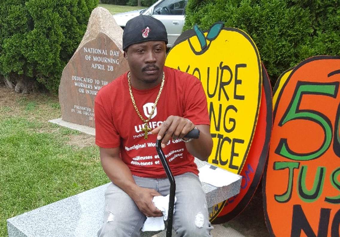 Jamaican Migrant Worker Kevin Campbell sits with his cane during a Justice For Migrant Workers rally, August 8, 2016 (Photo courtesy of Tanya Ferguson)
