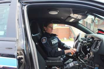Const. Renee Cowell with the Chatham-Kent Police Service in her cruiser. (Photo by Greg Higgins)