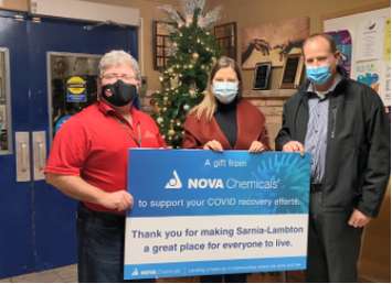 Myles Vanni at the Inn of the Good Shepherd accepts a donation from NOVA Chemicals on Giving Tuesday. Image courtesy of NOVA Chemicals.
