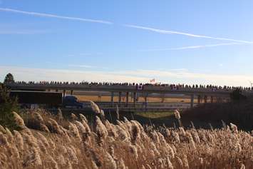 Supporters come out to the Communications Rd. overpass on Hwy. 401 for the repatriation ceremony of fallen veteran and Wheatley native John Gallagher on November 20, 2015. (Photo by Ricardo Veneza)