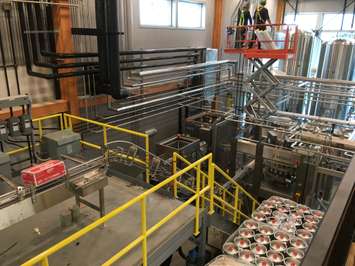 A look down at kegs ready to be filled, and the auto-canning equipment at Cowbell. August 3rd, 2017 (Photo by Ryan Drury)