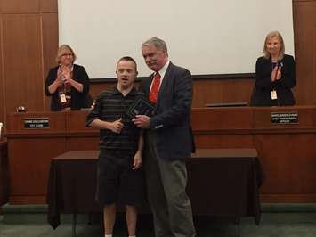 Cody Daye accepts his accessibility award from Mayor Mike Bradley. October 2, 2017 (Photo by Melanie Irwin)