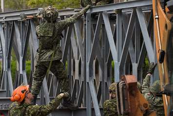 Members from 5 Combat Engineer Regiment install a temporary bridge at l’île Verte, in Laval in Quebec. File photo courtesy of DND 2022.