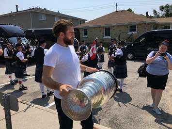 Ryan O'Reilly makes his way to the front entrance of Goderich Town Hall with the Stanley Cup through a crowd of fans. (Photo by Ryan Drury)