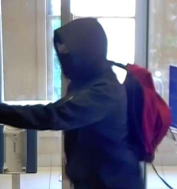 A third suspect caught on surveillance during a bank robbery in Harriston on June 22, 2022. (Image supplied by the OPP)