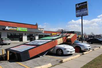 A sign fell on two cars at a plaza on St. Clair St. in Chatham. March 8, 2017. (Photo by Natalia Vega)