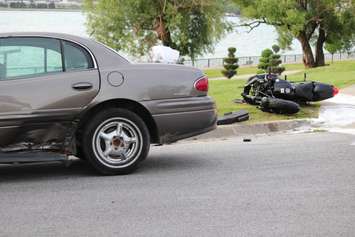 A motorcycle driver has been taken to hospital after colliding with a car on Riverside Dr. W at Askin Ave., June 19, 2015. (Photo by Jason Viau)