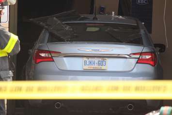 Three people were sent to hospital after a car smashes through the front of an RBC Bank on Huron Church Rd., July 3, 2015. (Photo by Jason Viau)