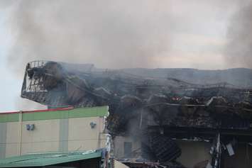 Hot spots continue to burn in the roof of the Windsor Raceway July 1, 2015.  (Photo by Adelle Loiselle)