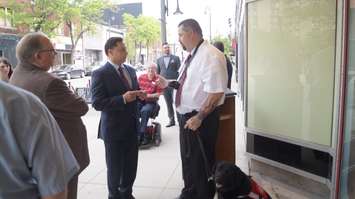 Economic Development and Infrastructure Minister Brad Duguid talks to local deaf resident about accessible options for viewing Imperial Theatre plays. May 29, 2015 (BlackburnNews.com Photo by Briana Carnegie).