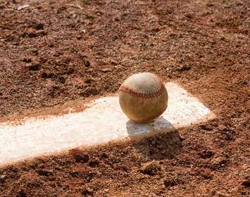 Baseball sitting on a pitcher's mound. © Can Stock Photo / beichh4046