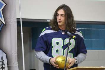 Seattle Seahawks Tight End Luke Willson presents St. Thomas of Villanova High School with a golden football, on behalf of the NFL, November 6, 2015. (Photo by Mike Vlasveld)