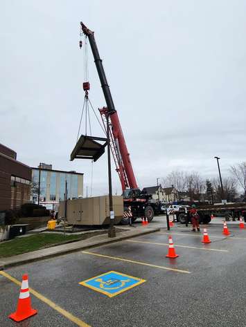 Workers use a crane outside Sarnia Police headquarters. 4 April 2023. (Photo by Melanie Irwin)