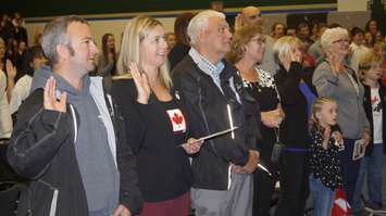 New Canadians take the oath of citizenship during a ceremony at St. Patrick's High School. May 3, 2017 (Photo by Melanie Irwin)