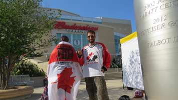 Laura Walker and Graham Caracciolo sport a Tragically Hip flag and hockey jersey signed by the iconic band outside of Budweiser Gardens, August 8, 2016. (Photo by Miranda Chant, Blackburn News)