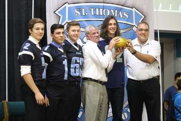 Seattle Seahawks Tight End Luke Willson presents St. Thomas of Villanova High School with a golden football, on behalf of the NFL, November 6, 2015. (Photo by Mike Vlasveld)