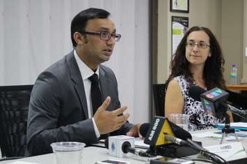 Medical Officer of Health Dr. Wajid Ahmed speaks, alongside Water Quality Scientist Katie Stammler, at the Windsor-Essex County Health Unit, July 24, 2015. (Photo by Mike Vlasveld)