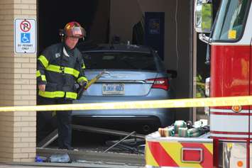 Three people were sent to hospital after a car smashes through the front of an RBC Bank on Huron Church Rd., July 3, 2015. (Photo by Jason Viau)