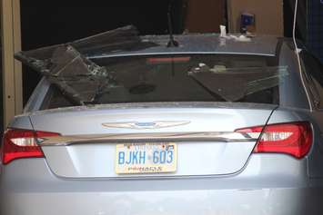 Three people were sent to hospital after a car smashes through the front of an RBC Bank on Huron Church Rd., July 3, 2015. (Photo by Jason Viau)