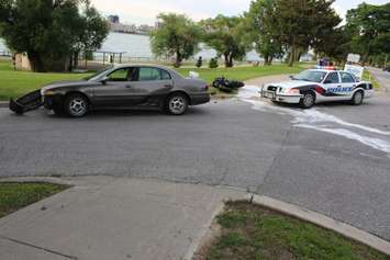 A motorcycle driver has been taken to hospital after colliding with a car on Riverside Dr. W at Askin Ave., June 19, 2015. (Photo by Jason Viau)