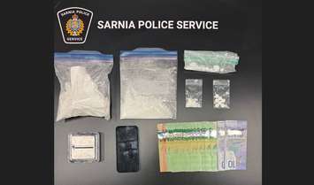 Suspected cocaine, oxycodone pills, and cash seized in traffic stop. October 23, 2025. (Photo courtesy of the Sarnia Police Service) 