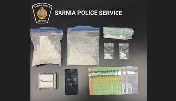 Suspected cocaine, oxycodone pills, and cash seized in traffic stop. October 23, 2025. (Photo courtesy of the Sarnia Police Service) 