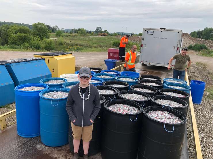 Jace Weber stands among the many pop tabs he collected for charity. Photo by Candice Weber