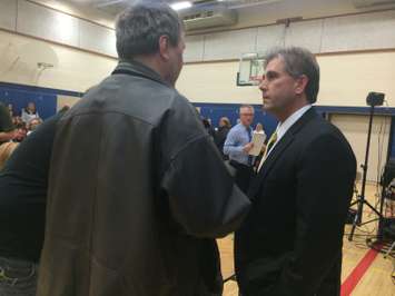 GECDSB Superintendent Todd Awender (R) speaks with a member of the public at a meeting at Harrow District High School on March 2, 2015. (Photo by Ricardo Veneza)