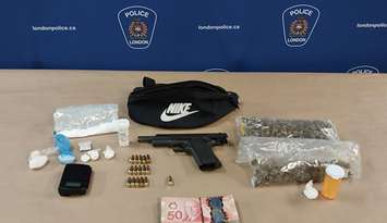 A semi-automatic pistol, drugs, and cash seized by London police, September 21, 2023. Photo courtesy of London police.