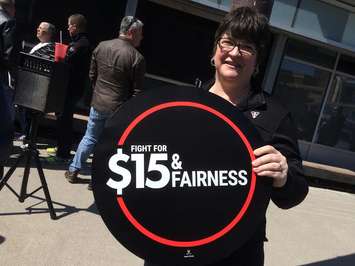 A demonstrator attends a downtown Windsor rally supporting $15/hr minimum wage in Canada. Photo taken April 15, 2016.