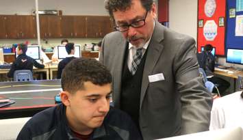 Rocky Ieraci working with one of his students at Holy Names Catholic High School in Windsor.
(Photo courtesy of Stephen Fields/Windsor-Essex Catholic District School Board)