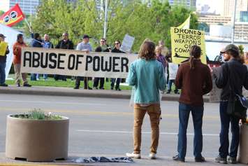Protesters gather outside the Waterfront Hotel in downtown Windsor during Prime Minister Stephen Harper's visit to the city, May 13, 2015. (Photo by Jason Viau)