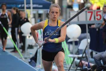 Athletes compete in a pole vaulting competition on Ouellette Ave., May 22, 2015. (Photo by Jason Viau)