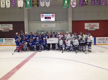 Both teams after skating hard to entertain the fans. (Photo by Steve Sabourin)