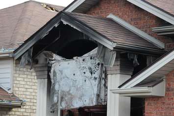 Fire investigators comb through a house on Spago Cres. after a weekend blaze, March 30, 2015. (Photo by Jason Viau)