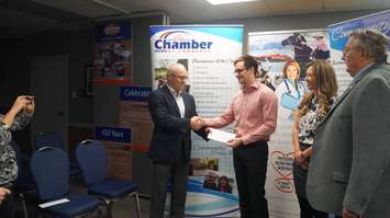 The Sarnia-Lambton Chamber of Commerce Legacy Scholarship Awards presents Dr. Mark Mousseau with $3,000. The second recipient, Dr. Amanda Rosenblum, could not attend Wednesday. December 16, 2015 (BlackburnNews.com Photo by Briana Carnegie)