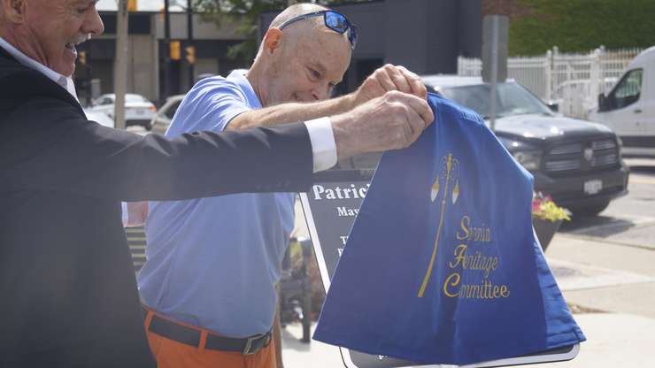 Ted McLean unveils a plaque commemorating his late mother, Patricia McLean. July 19, 2023. (Photo by Natalia Vega)