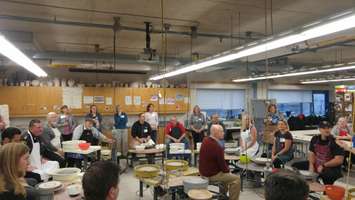 Local celebrities being instructed on how to create their pottery bowls. February 23, 2018. (Photo by Colin Gowdy, Blackburn News)