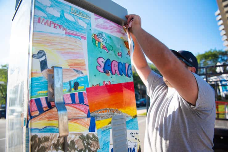 Vinyl wrap being installed on one of the traffic boxes in Sarnia. August 2026. (Photo courtesy of the City of Sarnia)