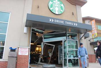 Officials deal with the fallout after a car smashed through a coffee shop on Dougall Ave. in Windsor on March 30, 2016. (Photo by Ricardo Veneza)