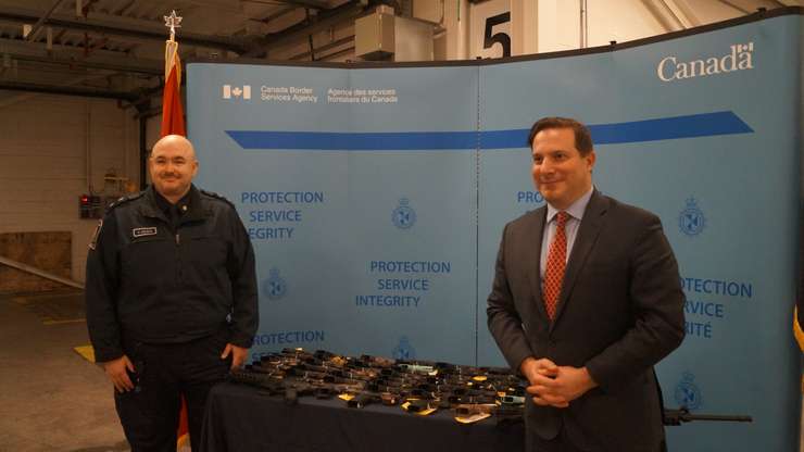 Public Safety Minister Marco Mendicino and CBSA Acting Director Rob Wilson stand in front of nearly 60 firearms seized at the Blue Water Bridge. January 17, 2023. (Photo by Natalia Vega)