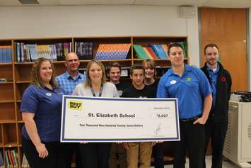 Best Buy reps presenting a grant to the St. Elizabeth Catholic School. November 2, 2016. (Photo by Natalia Vega)